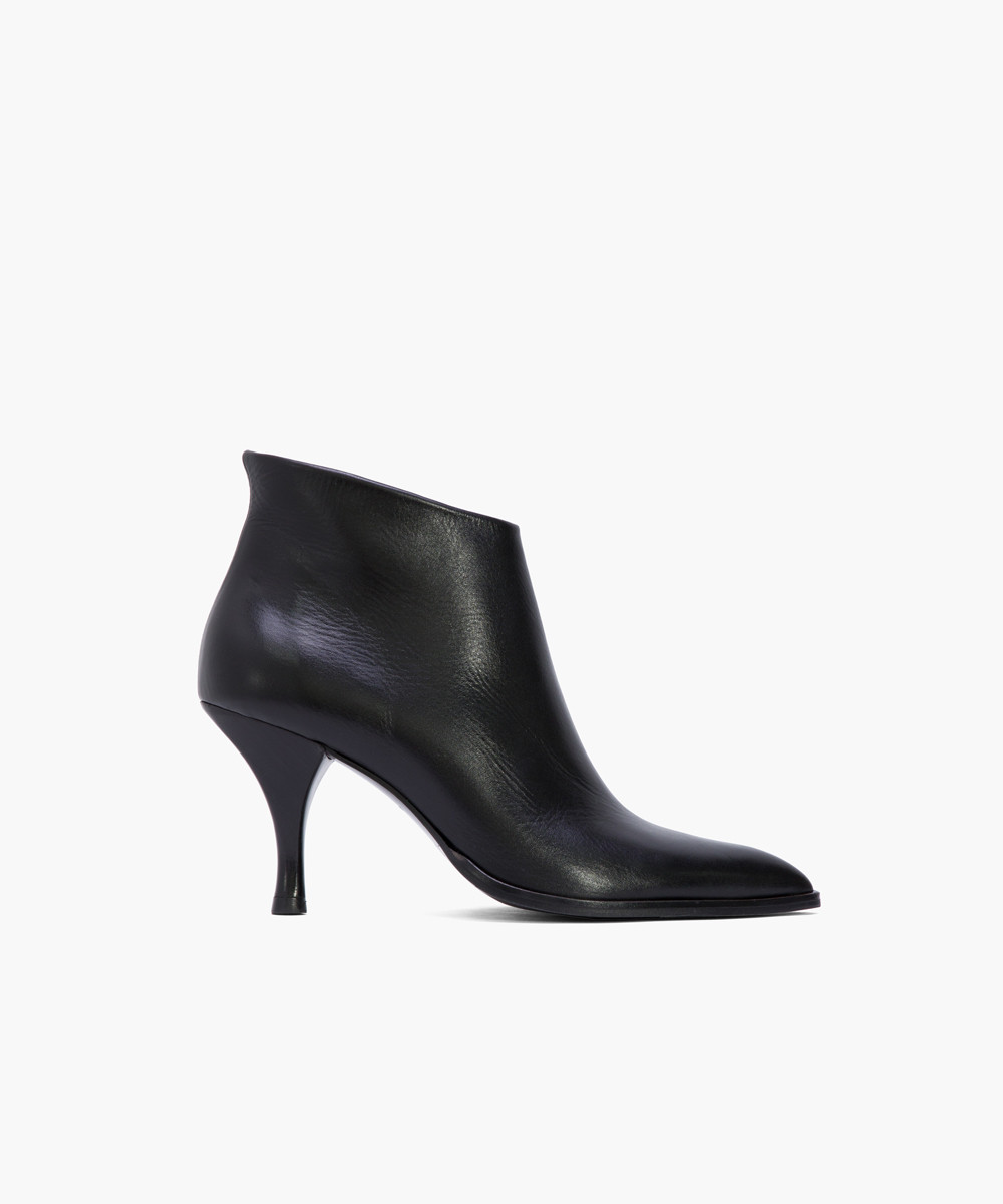 Black supple leather slanted cut low ankle boots